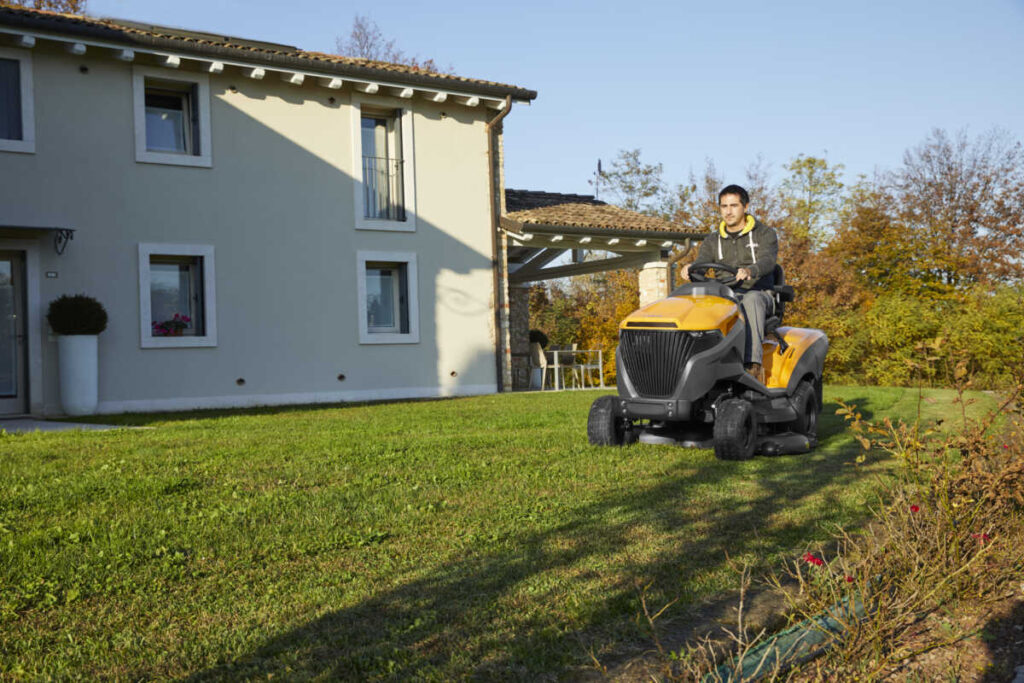 Home owner mowing garden with Stiga Estate 9122 W